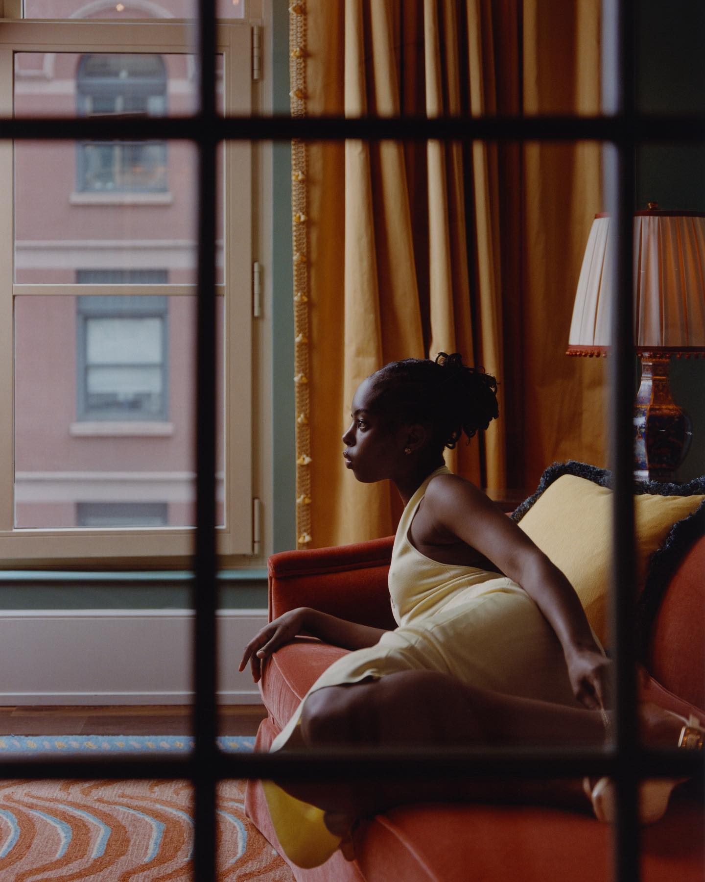 A modern flâneuse sits within walls first imagined in the Gilded Age, where the spirit of the mansion reveals itself through texture and time.