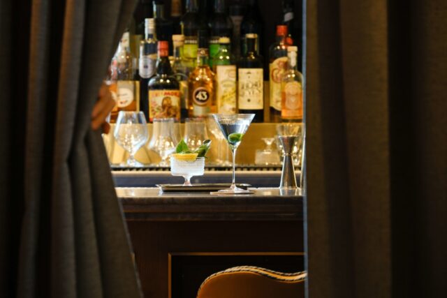 Welcome to the best seat in the house. Created exclusively for guests of The Fifth, Behind the Curtain is a reservation-only cocktail experience tucked into a jewel-box bar on the mezzanine of Café Carmellini. Offered once per night, the experience invites two guests into a quiet, behind-the-scenes journey of cocktails, canapés, and the theatre of fine dining in motion.